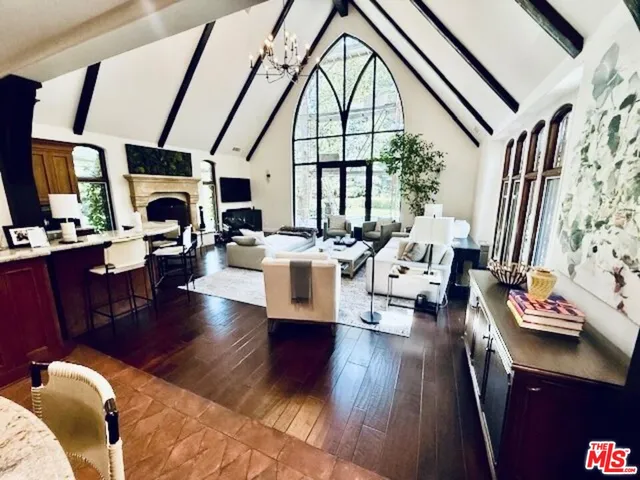 a kitchen with a table chairs and a wooden floor
