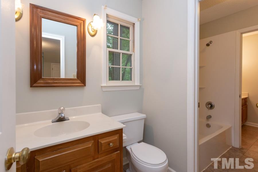 6917 Sandringham Drive Raleigh, NC 27613 - Photo 14 of 25 Tub is located just a few steps away which sits between both sinks and toilets, perfect for his and her or roommate situation!