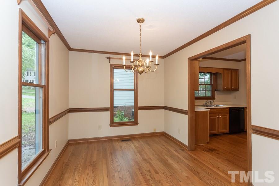 6917 Sandringham Drive Raleigh, NC 27613 - Photo 2 of 25 Spacious dining room with refinished hardwood floors and new paint!