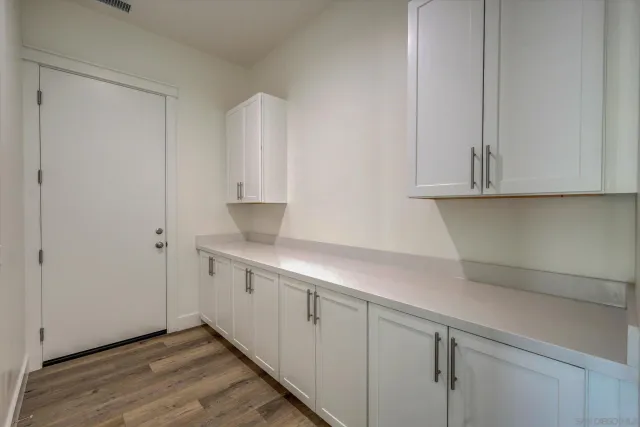 a kitchen with stainless steel appliances white cabinets and a sink