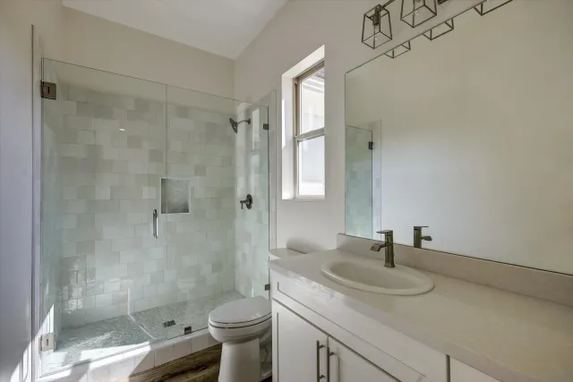 a bathroom with a sink toilet and shower
