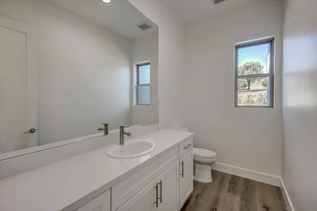 a bathroom with a sink toilet and vanity