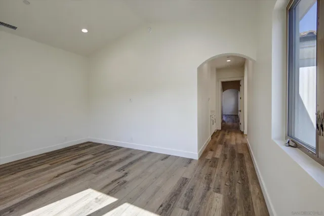 a view of a room with wooden floor and a balcony