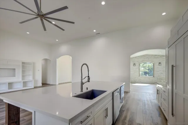 a kitchen with counter top a sink and dishwasher
