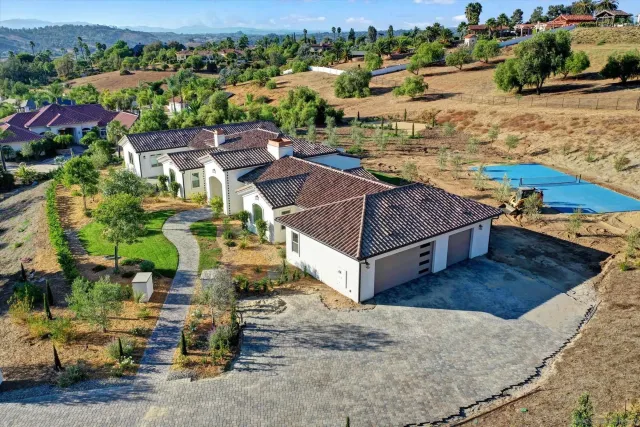 an aerial view of residential houses with outdoor space