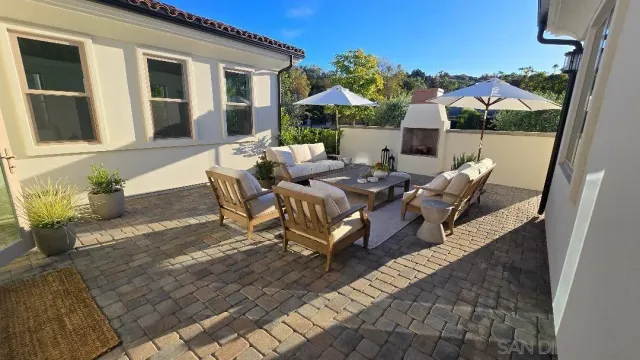 a view of a house with backyard and sitting area