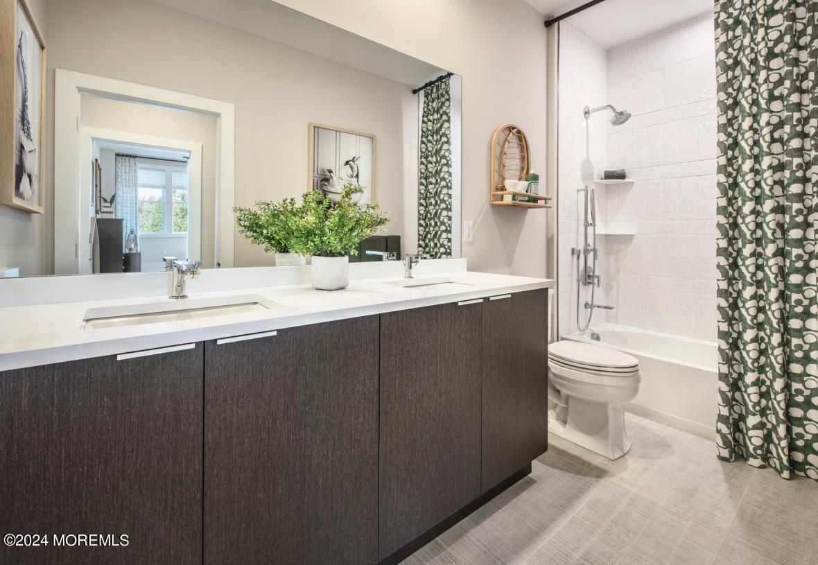 10 Waller Drive Middletown, NJ 07748 - Photo 9 of 25 a bathroom with a double vanity sink toilet mirror and shower