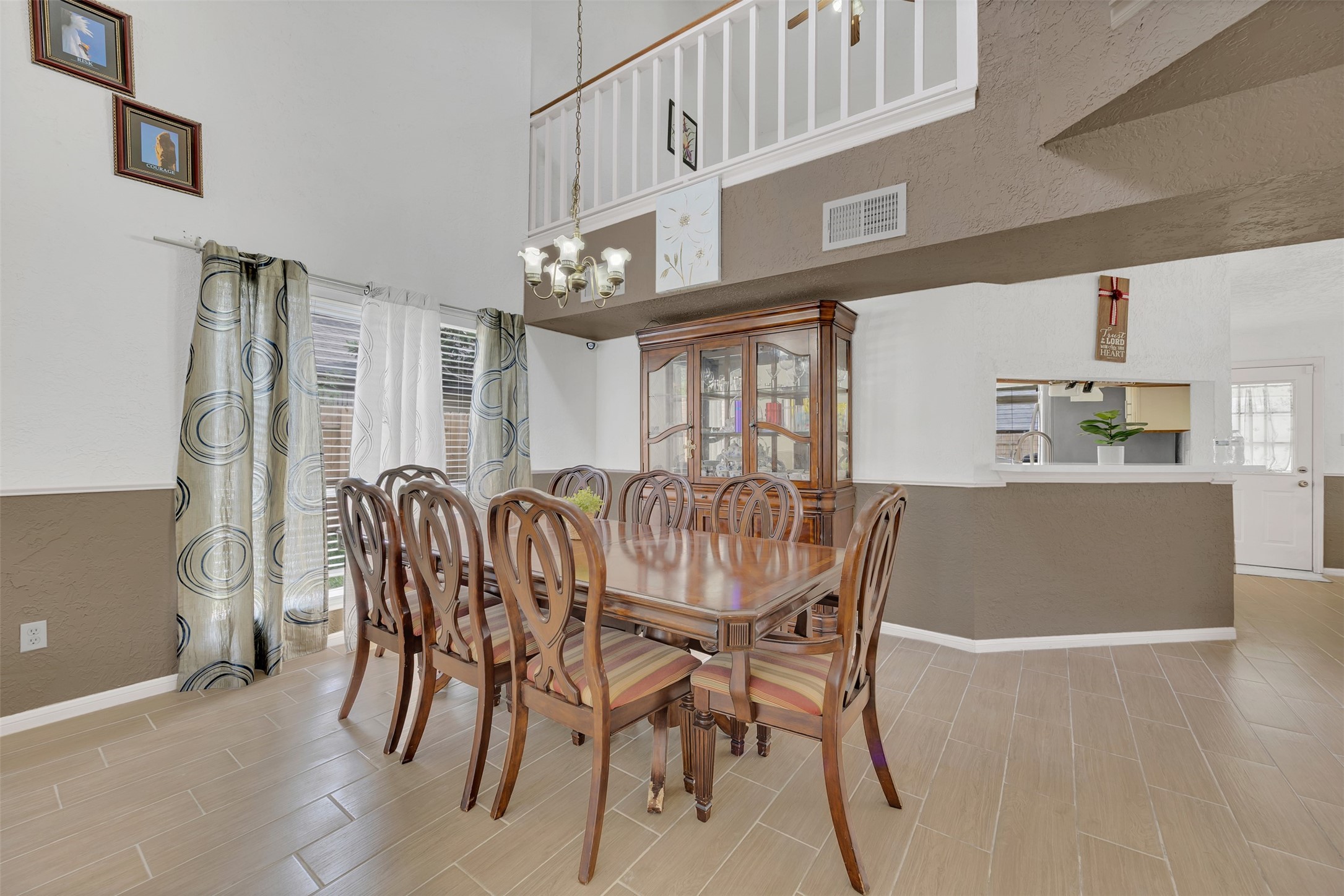 15619 Beechnut Street Houston, TX 77083 - Photo 6 of 29 Elegant formal dining space with high ceilings and room for a large table, ideal for family dinners or hosting guests.