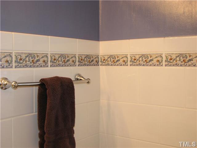 1651 Sutton Drive Raleigh, NC 27605 - Photo 15 of 25 The upstairs bathroom has been updated with fresh tile, including an attractive accent border.