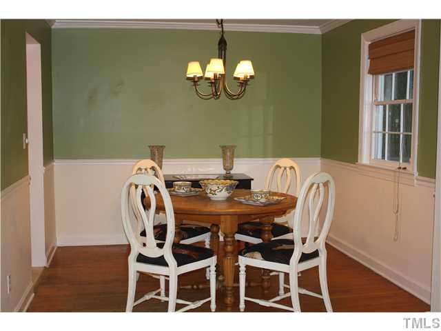 1651 Sutton Drive Raleigh, NC 27605 - Photo 5 of 25 Crown molding and chair railing add a touch of class to the dining room.