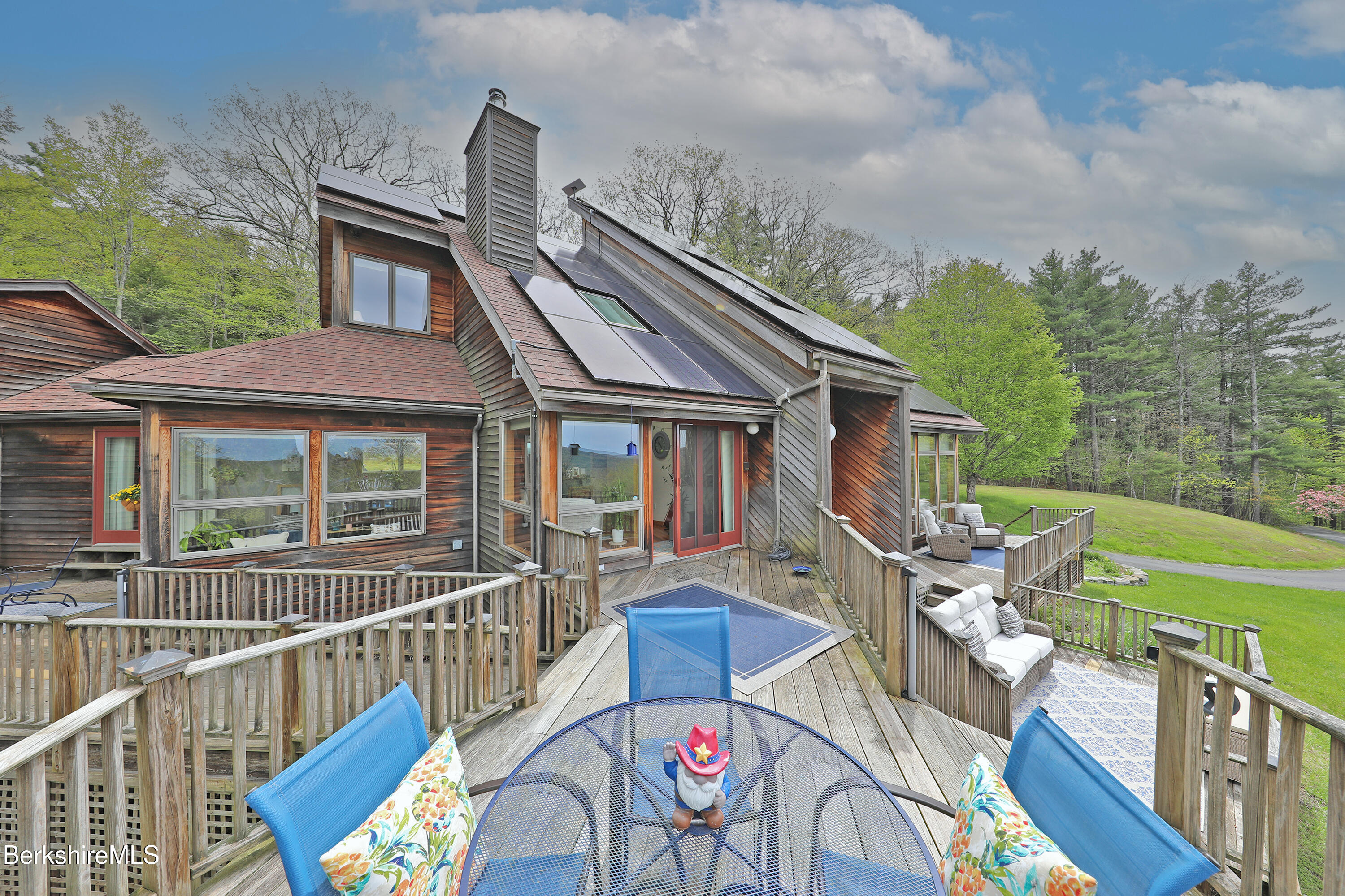 a view of a house with pool and chairs