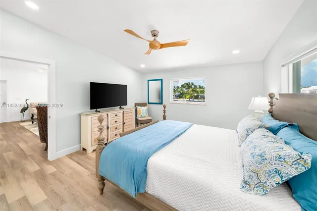 a spacious bedroom with a bed and a chair