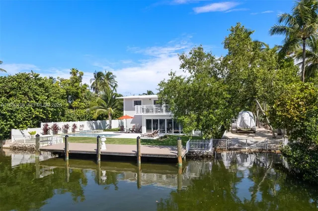 a front view of a house with garden and sitting area
