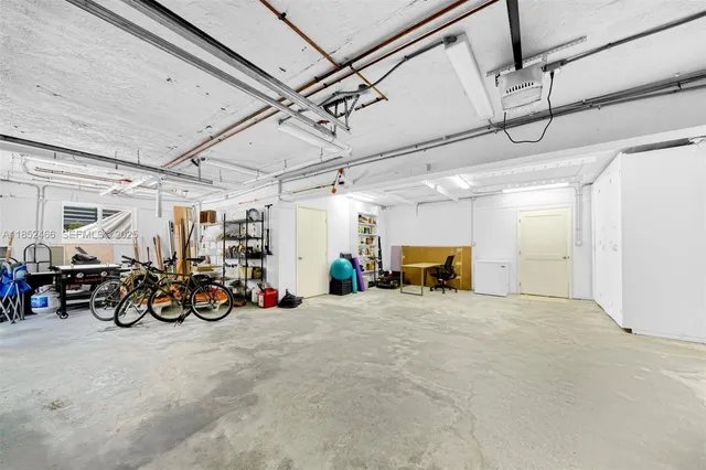 a view of a lake with a yard and large trees