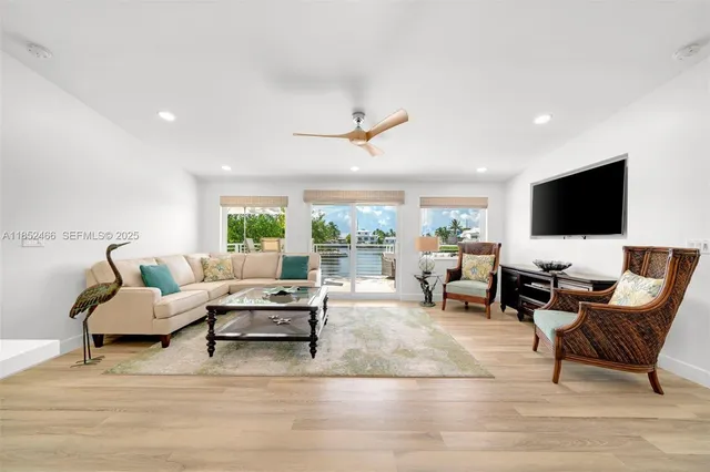 a living room with furniture and large windows