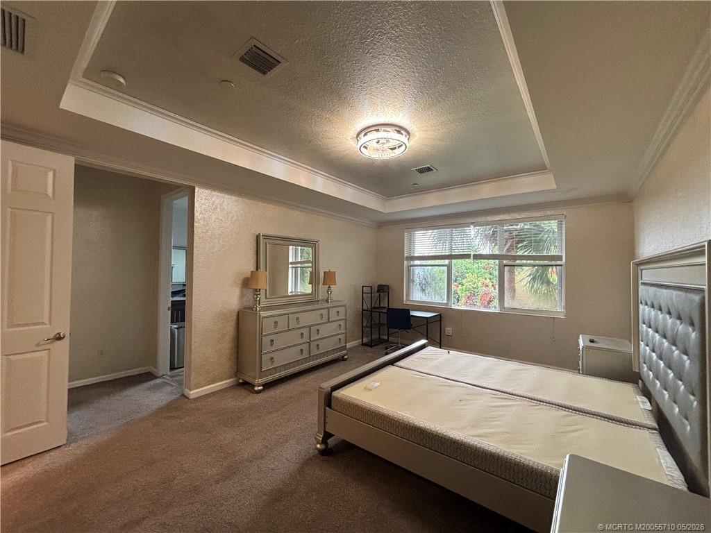 262 Southwest Walking Path, Unit 262 Stuart, FL 34997 - Photo 25 of 39 a bedroom with a bed and a large window