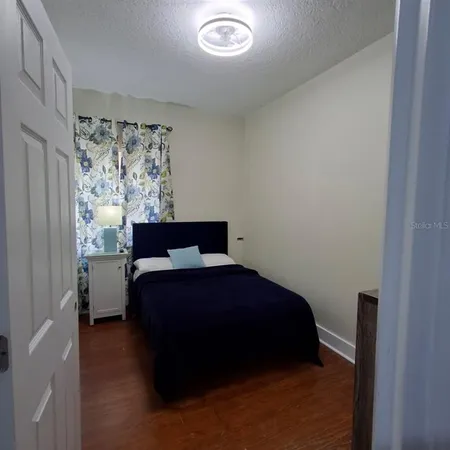 a bedroom with a bed and window