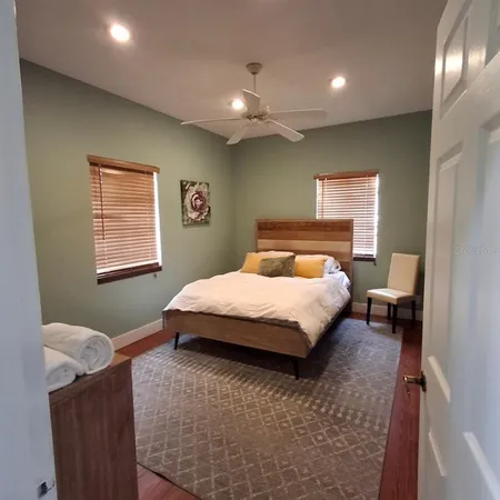 a bedroom with a bed and a lamp with window