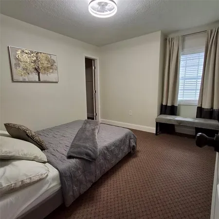 a bedroom with bed and a window