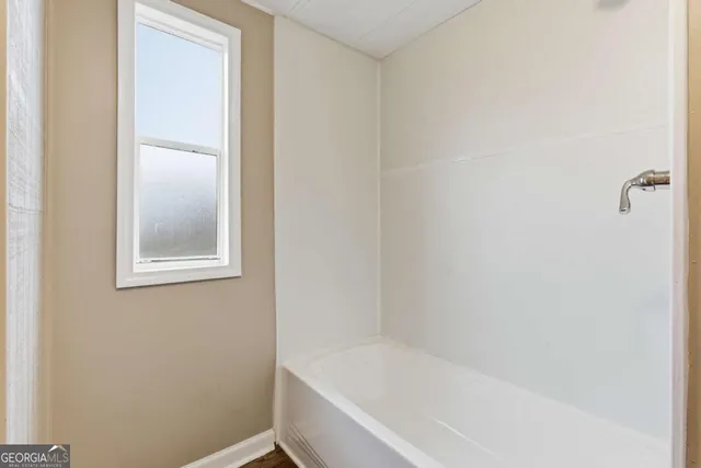 a white bath tub sitting next to a window