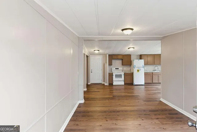 a view of a kitchen with wooden floor