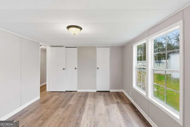 a view of a room with wooden floor and windows