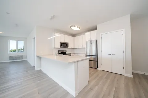 a kitchen with stainless steel appliances a refrigerator and a stove top oven
