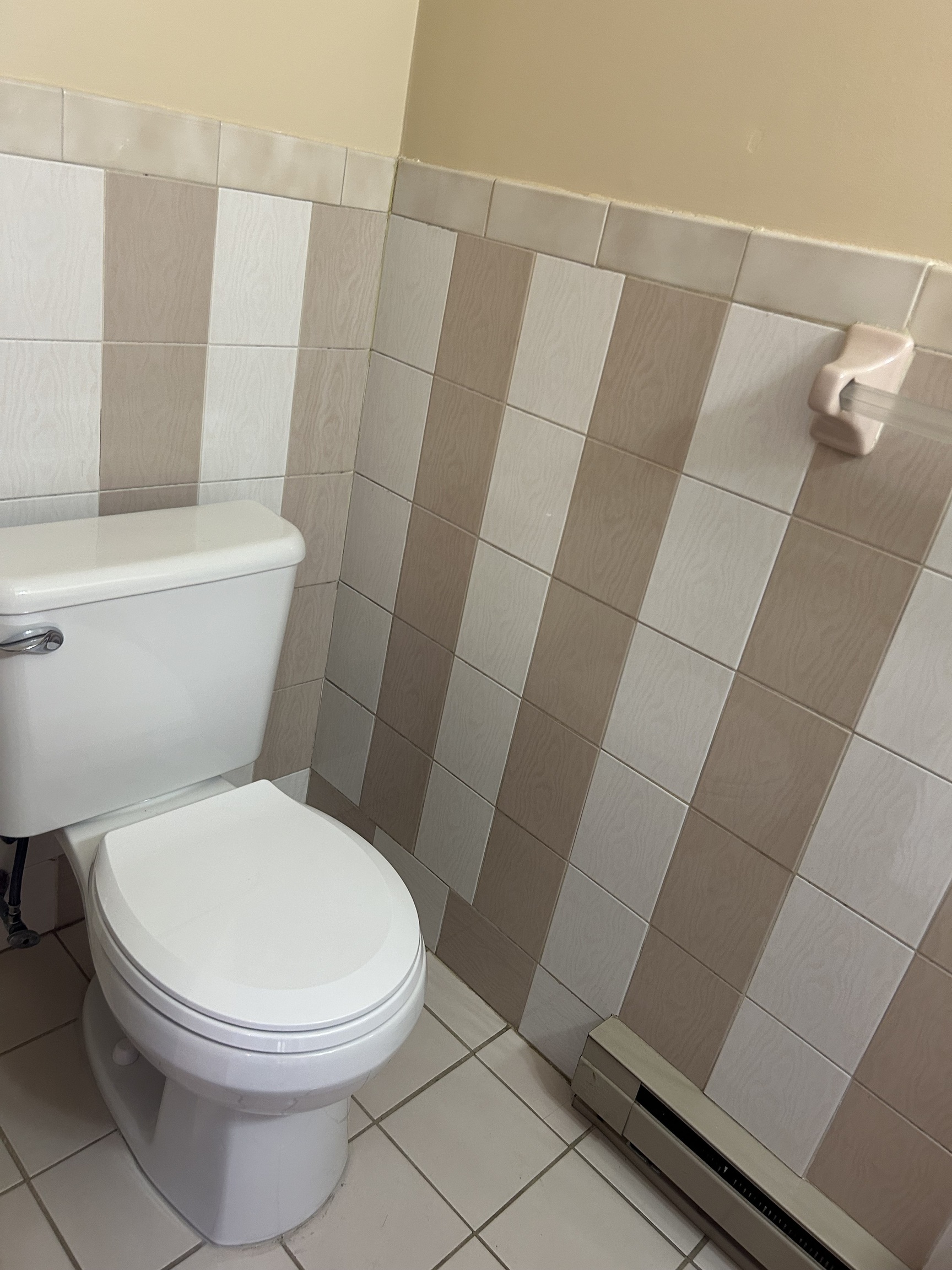 329 Scott Road, Unit B8 Waterbury, CT 06705 - Photo 12 of 16 a white toilet sitting next to a white sink and vanity