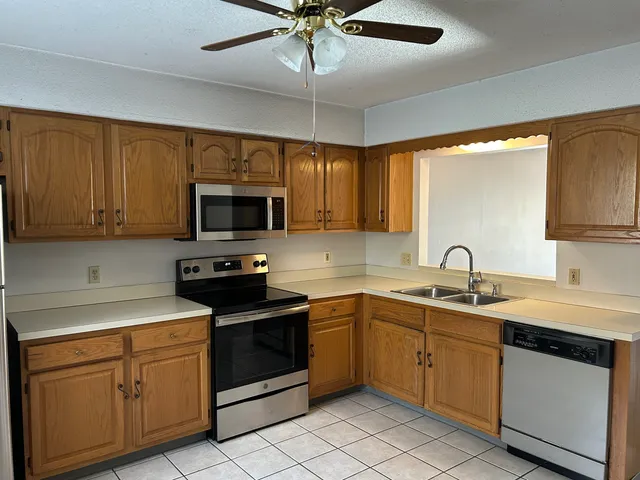 a kitchen with a sink stove and microwave