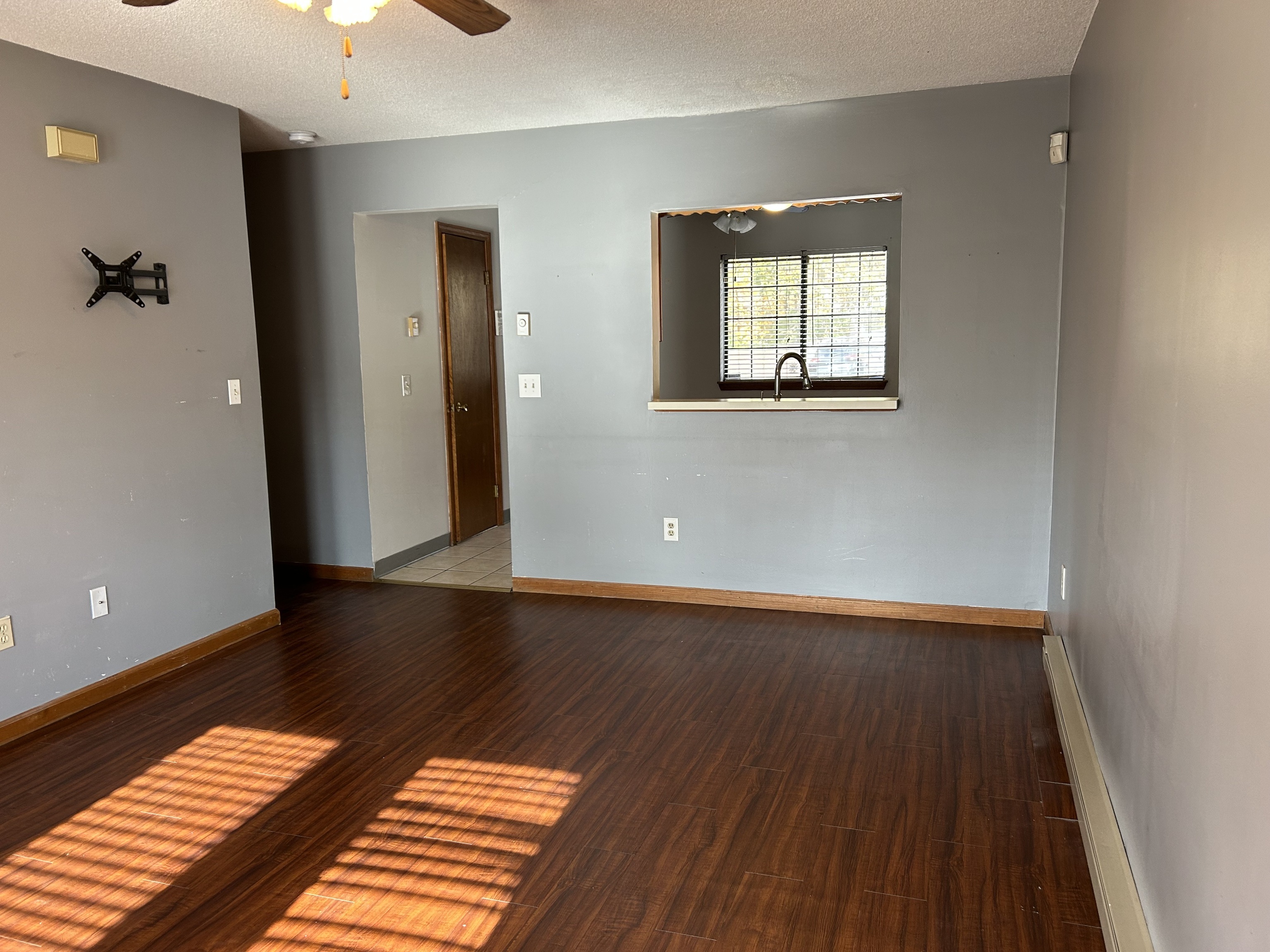 329 Scott Road, Unit B8 Waterbury, CT 06705 - Photo 5 of 16 an empty room with wooden floor and windows