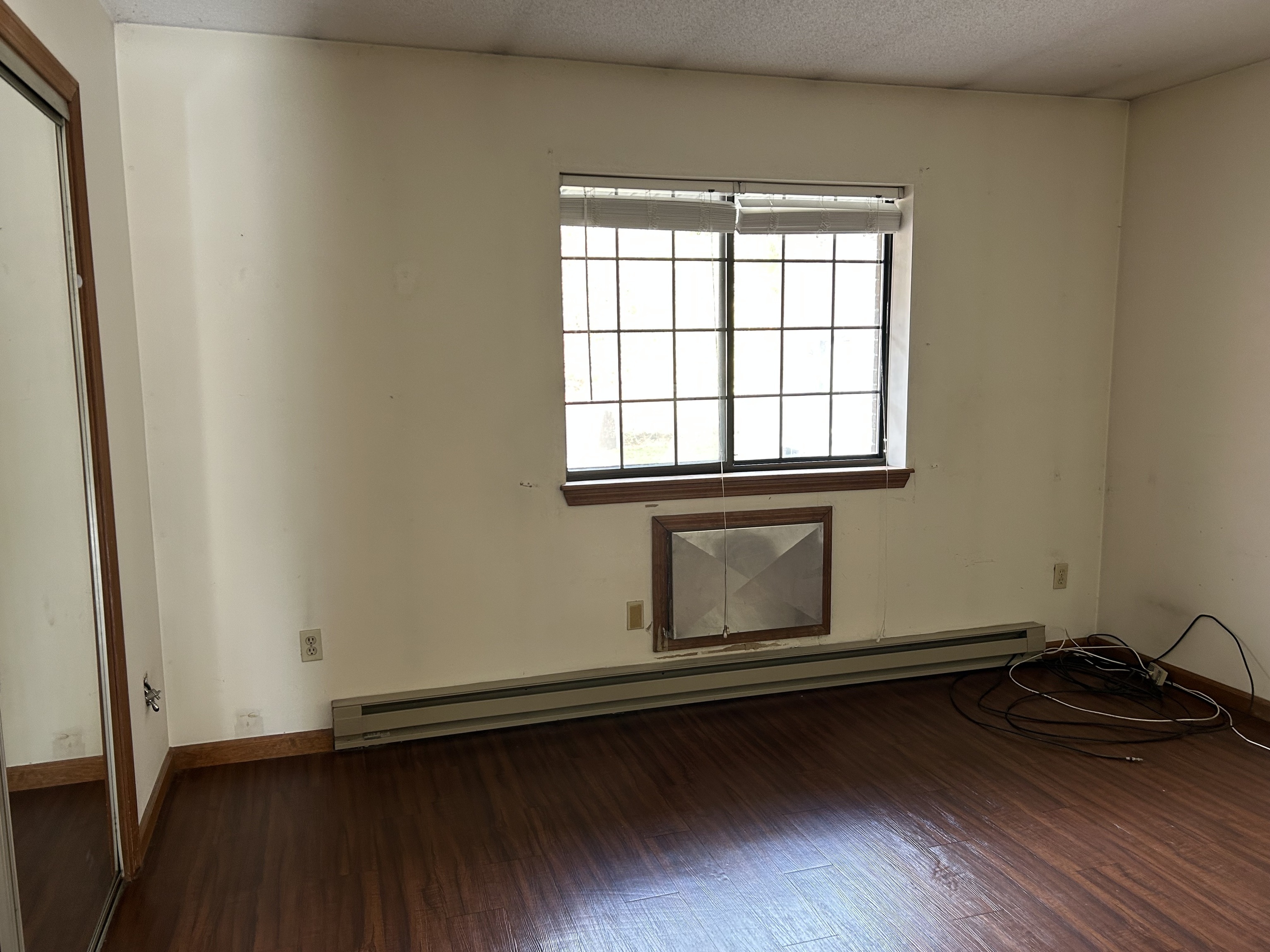 329 Scott Road, Unit B8 Waterbury, CT 06705 - Photo 7 of 16 an empty room with wooden floor and windows
