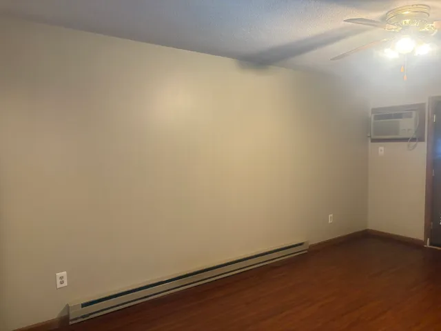 an empty room with wooden floor