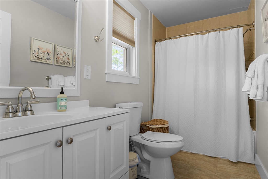 4 Hye Lane Edgartown, MA 02539 - Photo 9 of 41 a bathroom with a sink a toilet and shower curtain