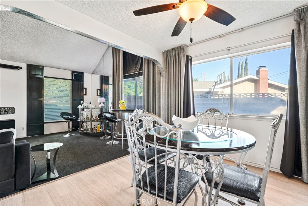 2130 Spice Street Lancaster, CA 93536 - Photo 11 of 45 a dining room with furniture a chandelier and wooden floor