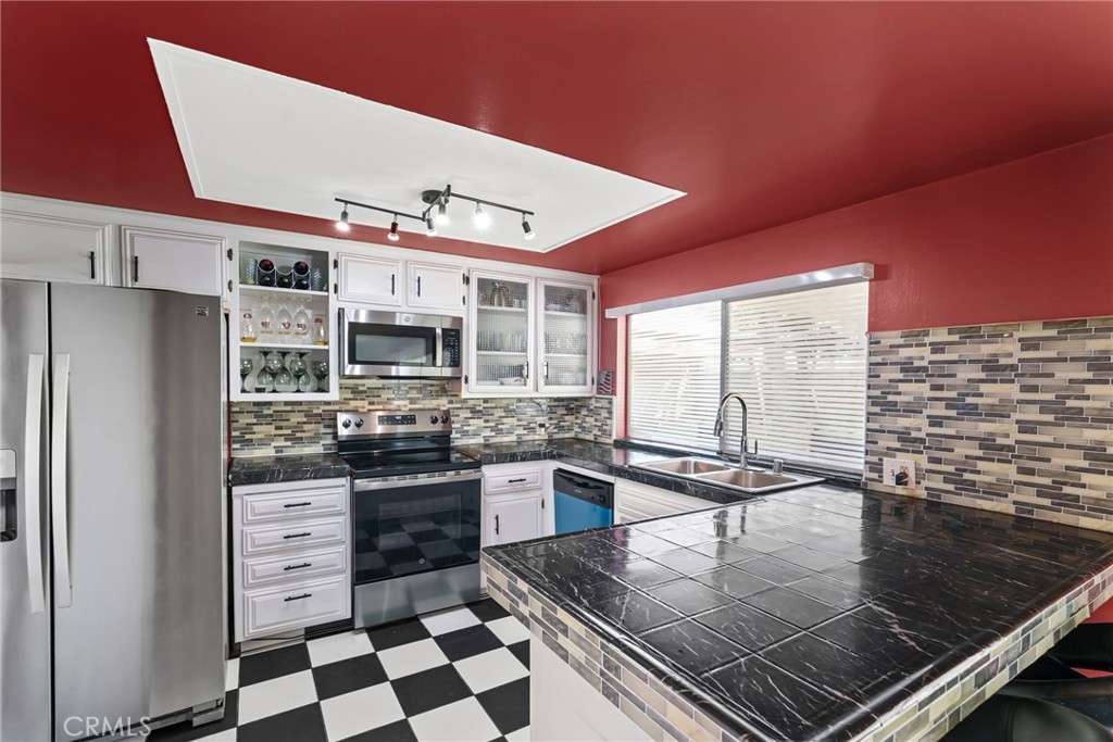 2130 Spice Street Lancaster, CA 93536 - Photo 12 of 45 a kitchen with stainless steel appliances granite countertop a stove a sink and a microwave