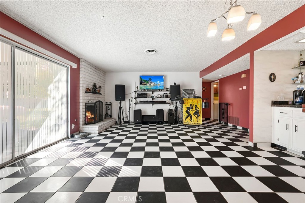 2130 Spice Street Lancaster, CA 93536 - Photo 17 of 45 a room with a black white checkered floor and a black white checkered floor with a rug