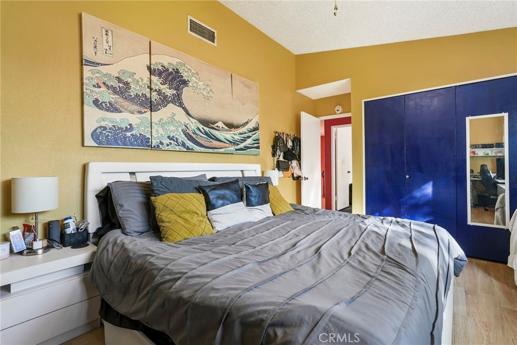 2130 Spice Street Lancaster, CA 93536 - Photo 24 of 45 a bedroom with a bed and a painting on the wall