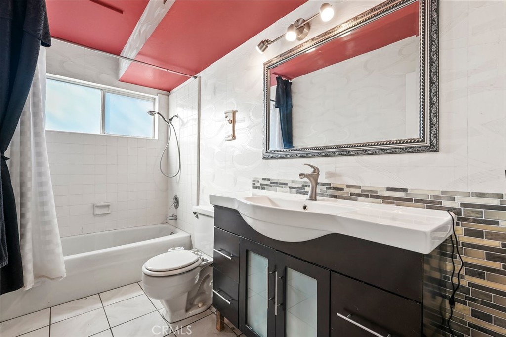 2130 Spice Street Lancaster, CA 93536 - Photo 31 of 45 a bathroom with a sink a toilet a mirror and shower