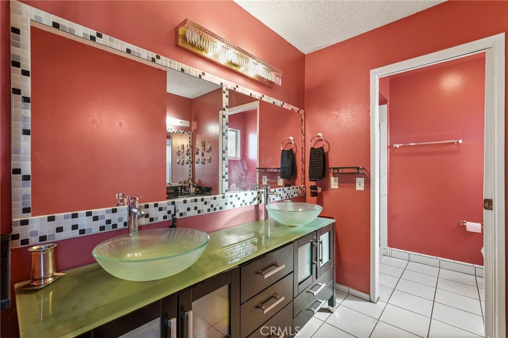 2130 Spice Street Lancaster, CA 93536 - Photo 32 of 45 a bathroom with a granite countertop sink and a mirror