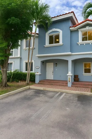 a house that has a tree in front of it