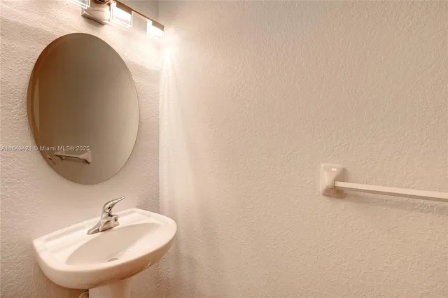 a bathroom with a sink and mirror