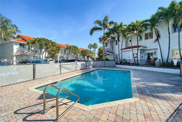 a swimming pool with outdoor seating and yard