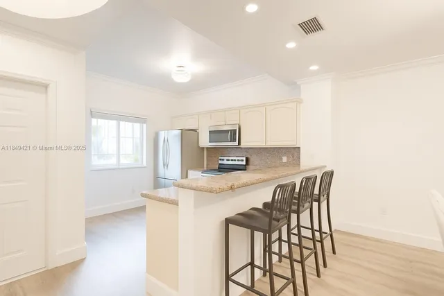 a kitchen with a table and chairs in it