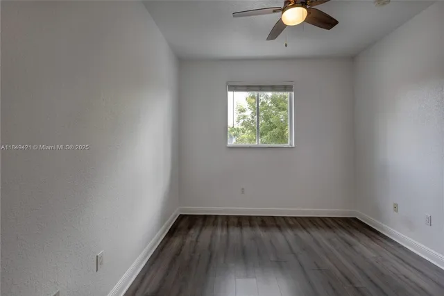 a view of a room with wooden floor and window