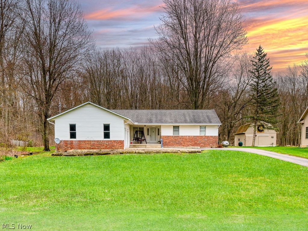 5175 Case Road North Ridgeville, OH 44039 - Photo 1 of 28 Ranch-style home with covered porch, a yard, and a garage