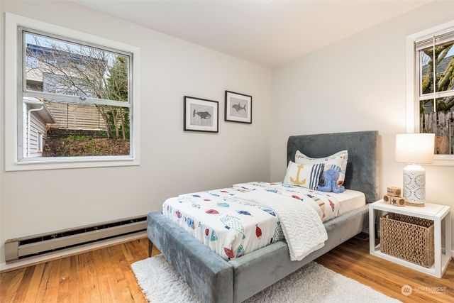 a bedroom with a bed and a painting on the wall