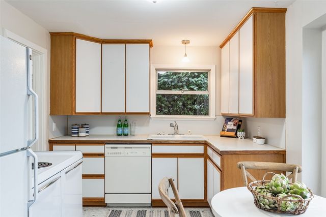 a kitchen with a sink cabinets and window