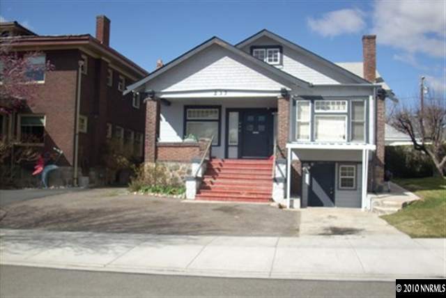 a front view of a house with a garden and plants
