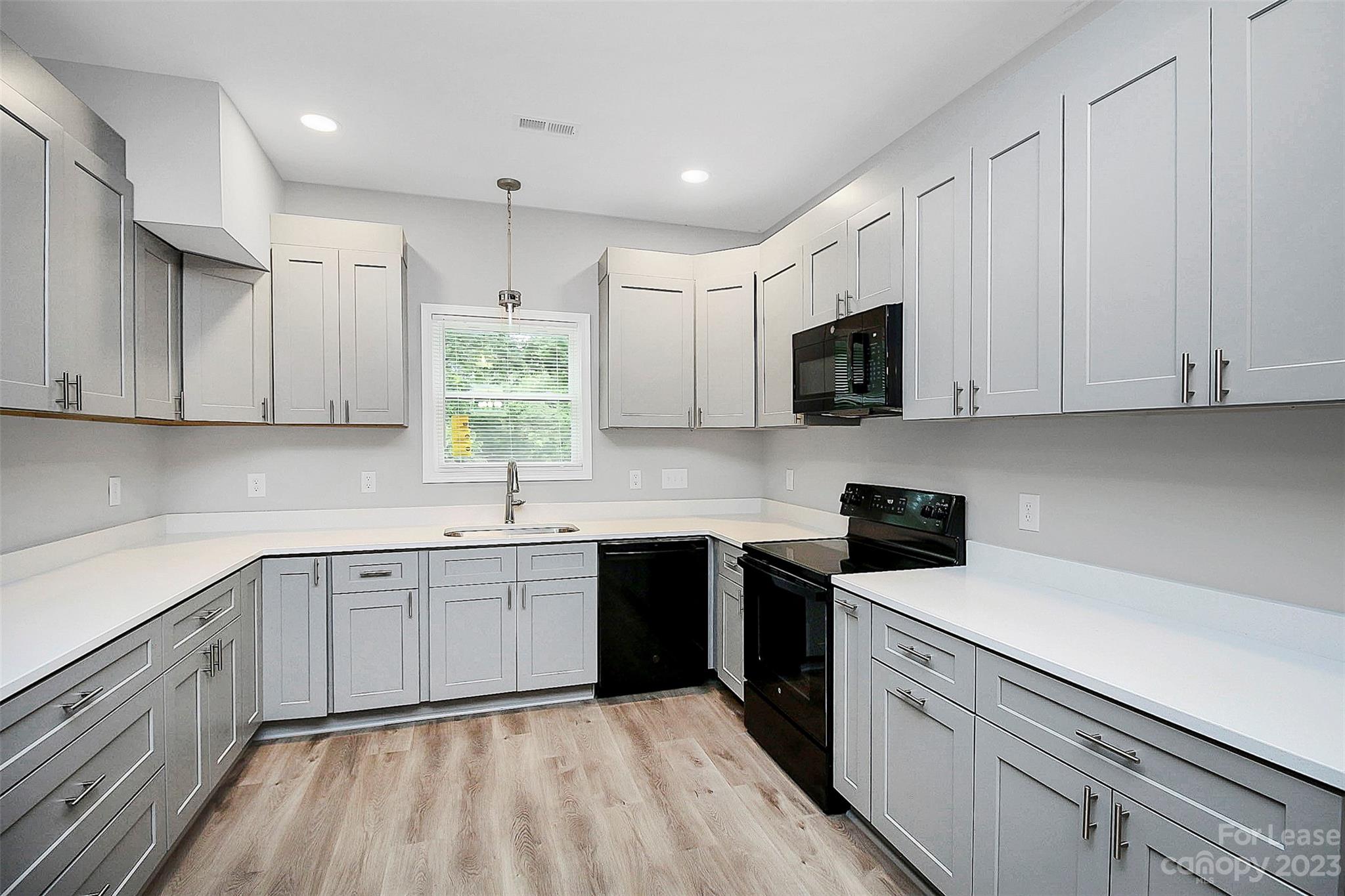 2301 Centergrove Road, Unit A Kannapolis, NC 28083 - Photo 6 of 12 a kitchen with a sink stove and cabinets