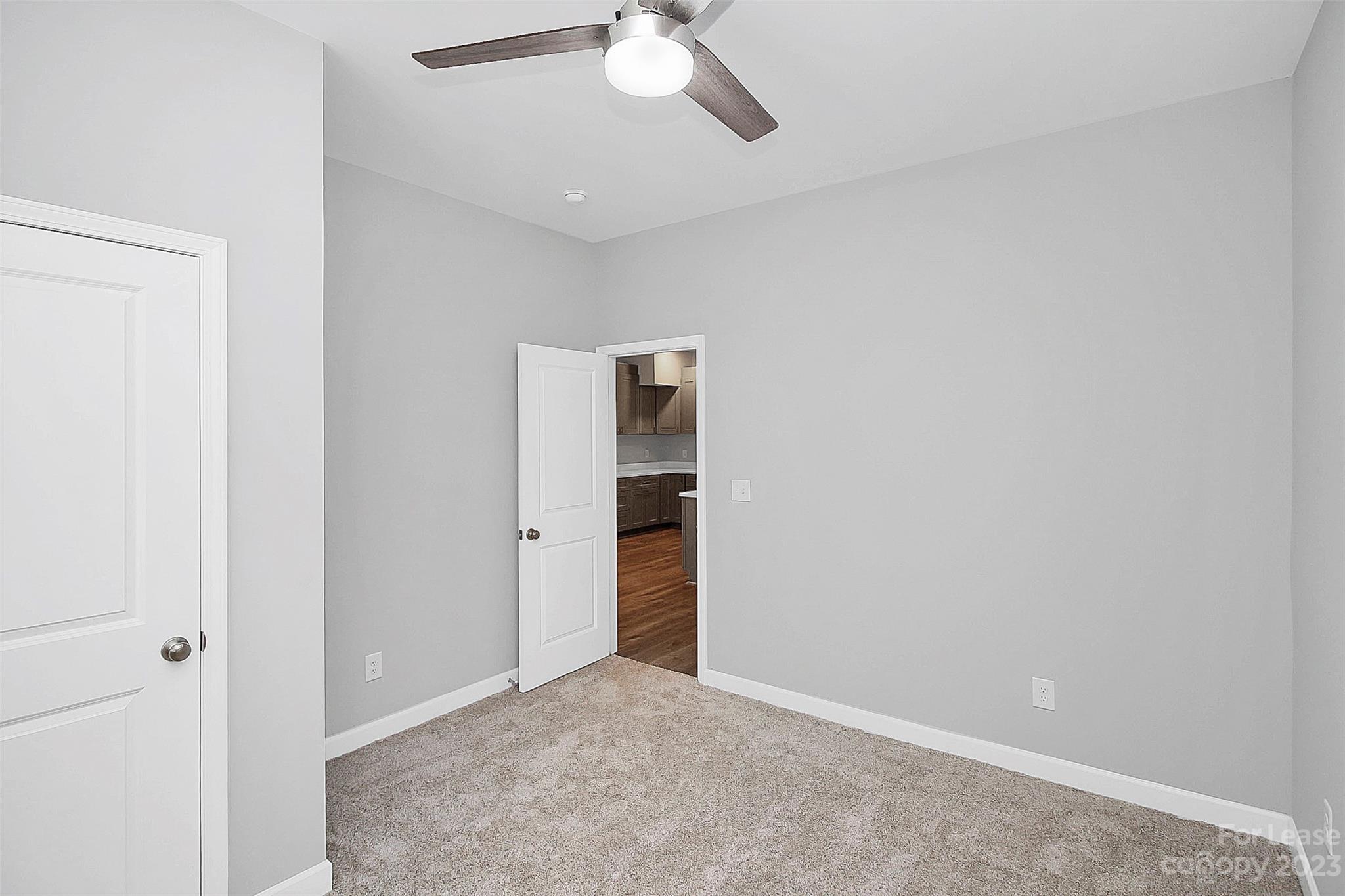 2301 Centergrove Road, Unit A Kannapolis, NC 28083 - Photo 8 of 12 an empty room with a ceiling fan and carpet